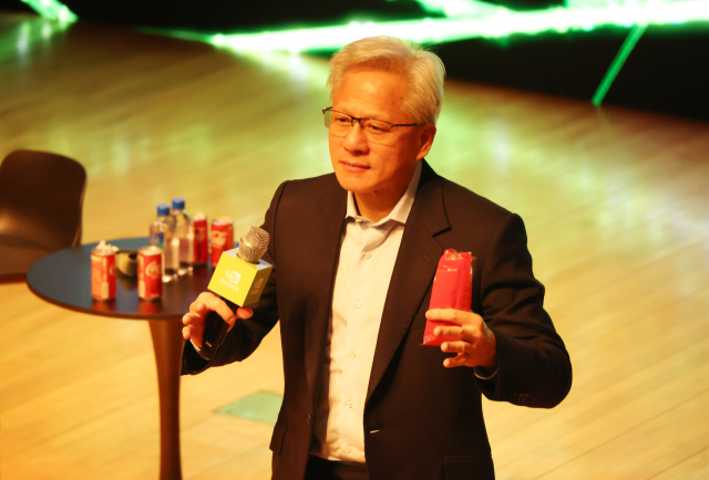 젠슨 황 엔비디아 최고경영자가 31일 경북 경주 예술의전당 원화홀에서 열린 2025년 아시아태평양경제협의체(APEC) 경주 엔비디아 기자간담회에서 빼빼로 과자를 먹다가 취재진 질문에 답하고 있다. 연합뉴스