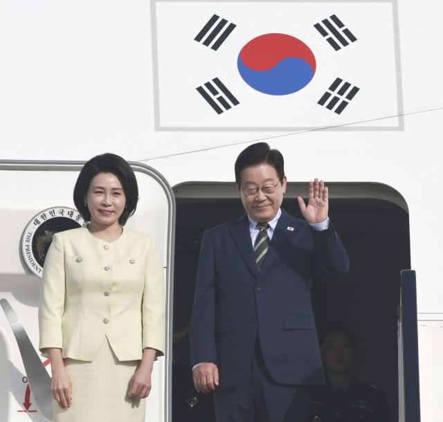 이집트 공식 방문을 마친 이재명 대통령과 김혜경 여사가 21일(현지시간) 남아공 주요 20개국(G20) 정상회의 참석을 위해 카이로 국제공항에서 공군 1호기에 올라 인사하고 있다. 연합뉴스