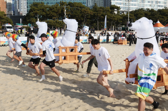 18일 열린 해운대 북극곰축제가 겨울 바다를 뜨겁게 달궜다. 입수뿐만 아니라 해변에서도 다양한 행사가 펼쳐졌다. 북극곰 가마 레이스. 이재찬·정종회·김종진 기자 chan@