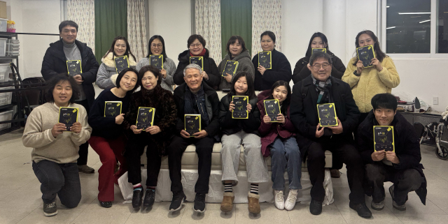 북구연극공동체 온 소속 세대별 극단 단원들이 '온도 80' 책자를 들고 기념사진을 찍고 있다. 북구연극공동체 온 제공