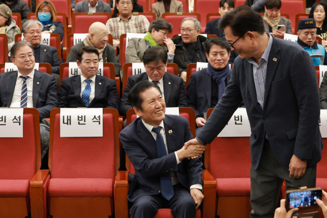 더불어민주당 정청래 대표가 10일 국회도서관에서 열린 같은 당 박찬대 의원 출판기념회에 참석해 소나무당 송영길 대표와 인사하고 있다. 연합뉴스