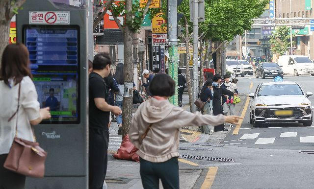 지난해 부산 시내버스 전면 파업 당시 부산 연제구 연산교차로에서 시민들이 버스정류장에서 급하게 택시를 잡고 있는 모습. 부산일보DB