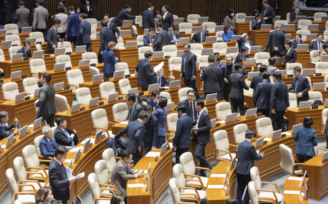 19일 국회에서 열린 3월 임시국회 2차 본회의에서 검찰 개혁 법안인 공소청법(대안)이 상정된 뒤 국민의힘 윤상현 의원(사진 왼쪽 아래)이 무제한 토론(필리버스터)을 하기 위해 연설대로 이동하자, 민주당 의원을 비롯한 의원들이 본회의장을 떠나고 있다. 연합뉴스