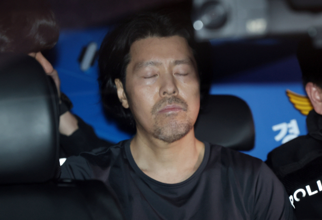 부산 항공사 기장 살해범 김동환이 지난달 26일 오전 부산 부산진경찰서에서 검찰로 송치되고 있다. 연합뉴스