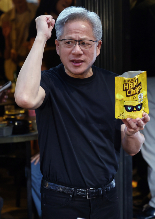 젠슨 황 엔비디아 최고경영자(CEO)가 5일 서울 마포구 홍대 인근 삼겹살 음식점 '형님 저요' 앞에서 HBM칩스를 나눠주며 파이팅을 하고 있다. 연합뉴스
