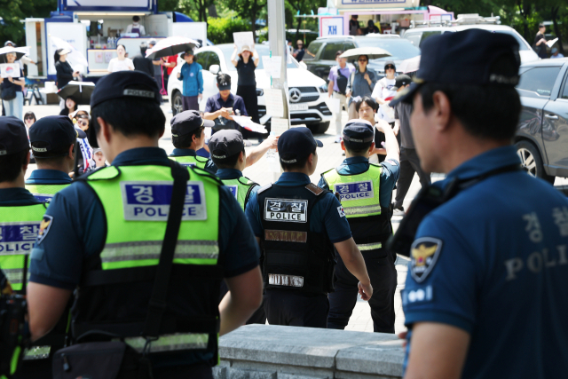 6·3 지방선거 투표용지 부족 사태를 규탄하며 재선거를 요구하는 '잠실 개표소 봉쇄 시위'가 계속되고 있는 9일 서울 송파구 올림픽공원 핸드볼경기장 출입구 앞에서 경찰들이 교대하고 있다. 연합뉴스